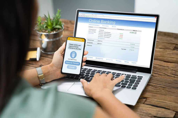 1542438851 Person using online banking on laptop and smartphone.