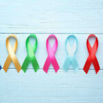 AI Uncovers Hidden Tumors—Doctors Stunned Colorful awareness ribbons on light wooden background