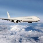 No-Fly Zone SLAMS Palm Beach Neighbors A white airplane flying above fluffy clouds in a blue sky