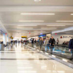 People walking through an airport terminal.