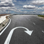 Curved road with a U-turn arrow marking.