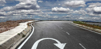 Curved road with a U-turn arrow marking.