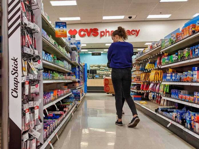 A person shopping in a CVS pharmacy aisle filled with various products