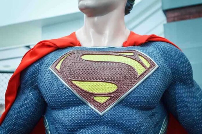 Close-up of a Superman statue wearing a blue costume and red cape