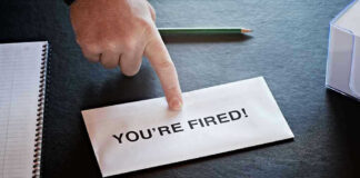 Envelope with YOURE FIRED and pointing finger.