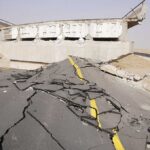Severely damaged road and collapsed bridge due to earthquake