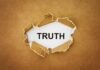 A piece of torn paper revealing the word TRUTH underneath