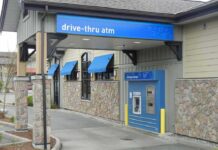 Drive-thru ATM at a bank with blue awnings
