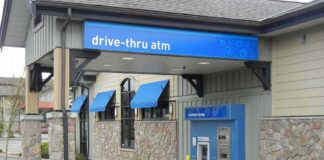 Drive-thru ATM at a bank with blue awnings