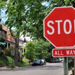 A red stop sign with the words STOP and ALL WAY in a residential area
