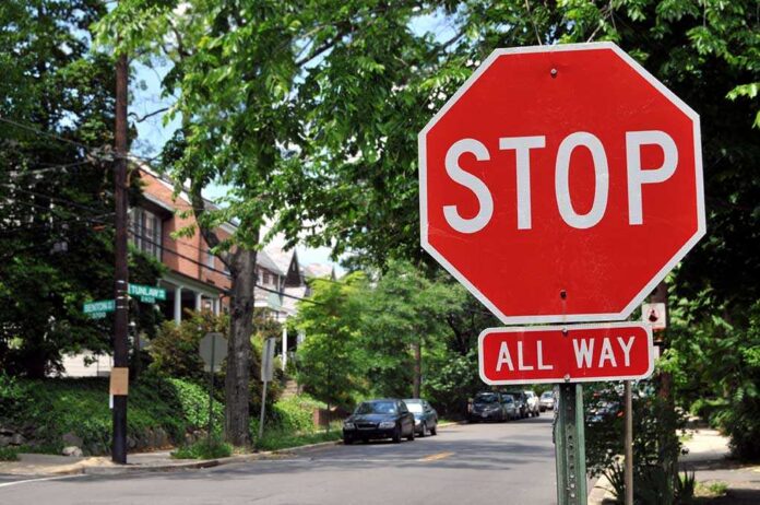 A red stop sign with the words STOP and ALL WAY in a residential area