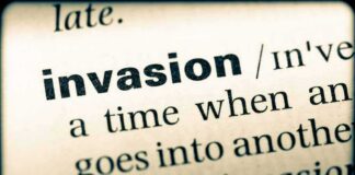 Close-up of a dictionary page showing the definition of the word invasion