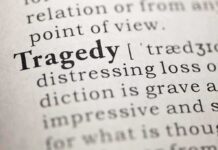 Close-up of the word 'Tragedy' in a dictionary with its definition
