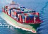A large cargo ship loaded with colorful containers sailing on the ocean