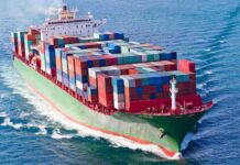 A large cargo ship loaded with colorful containers sailing on the ocean