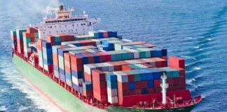 A large cargo ship loaded with colorful containers sailing on the ocean