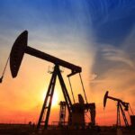 TRUMP INVOKED War Powers to Reboot California Oil Silhouetted oil pumps against a colorful sunset sky
