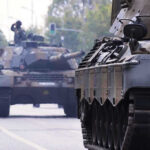 Abrams Tank Shocker: Radical Design Revealed! Tanks on a road with soldiers inside.