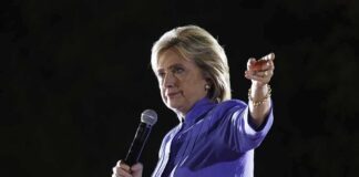 A woman speaking into a microphone at an outdoor event