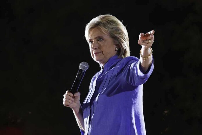 A woman speaking into a microphone at an outdoor event