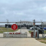 The Sovereignty Challenged by U.S. Strategic Plan Chain-link fence with Restricted Area Stop No Photography sign.