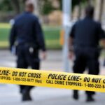 Mother, Grandmother, and Newborn Killed in Triple Stabbing Police officers walking past caution tape at a crime scene
