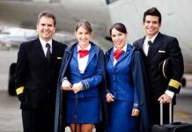 Group of airline crew members posing together at an airport