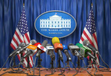 Vance Rejects Claims of Upfront Iran Payments Multiple microphones at White House press briefing podium.