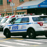 Video Shows NYPD Car Striking Jogger in Traffic Incident Police car and ambulances outside emergency room entrance.