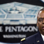 Hazmat Lockdown Sparks Questions After False Alarm Reports Man speaking in front of Pentagon sign.
