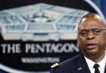 Hazmat Lockdown Sparks Questions After False Alarm Reports Man speaking in front of Pentagon sign.