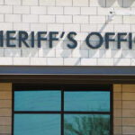 FBI Ends 15-Hour Hostage Standoff as All 10 Survive Sheriffs Office sign on brick building faade.