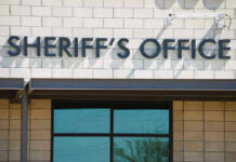 Sheriffs Office sign on brick building faade.