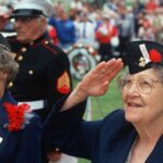 22 Flights Into Hell—One Hero’s Final Salute Elderly women in military attire saluting during a veterans ceremony
