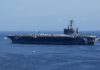 A large aircraft carrier sailing in the ocean
