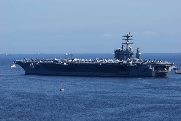 A large aircraft carrier sailing in the ocean