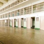 Prison U-Turn Sparks Fury in Scotland Interior view of a prison cell block with empty cells and security bars