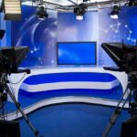 Election Questioning Ends Interview A television studio setup with cameras and a blue backdrop