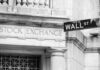 Competing Views of the Economy Fuel America’s Growing Trust Gap Stock Exchange building and Wall Street sign.