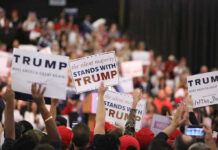 Minnesota Governor’s Race Heats Up Crowd holding signs supporting Trump at a rally.