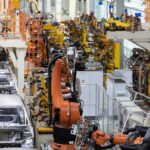 Industrial robots assemble car bodies on an automotive production line