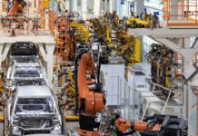 Industrial robots assemble car bodies on an automotive production line