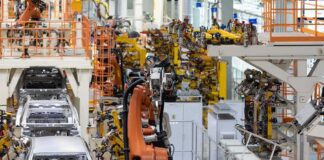 Industrial robots assemble car bodies on an automotive production line