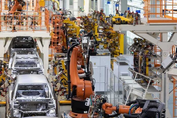 Industrial robots assemble car bodies on an automotive production line