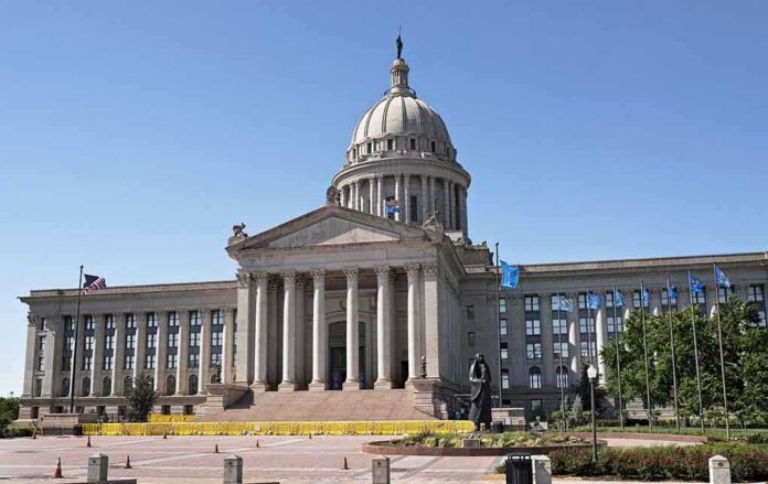 Exterior view of a state capitol building with a dome and flags