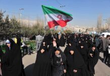 Stage-Managed Spectacle Targets America Group of women in black attire marching with an Iranian flag