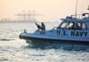 U.S. Navy patrol boat with armed crew on the water