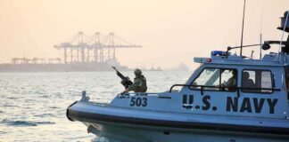U.S. Navy patrol boat with armed crew on the water