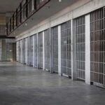 prison cell block with metal barred doors