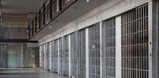 prison cell block with metal barred doors